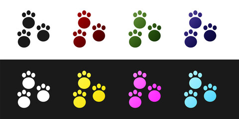 Set Paw print icon isolated on black and white background. Dog or cat paw print. Animal track. Vector.