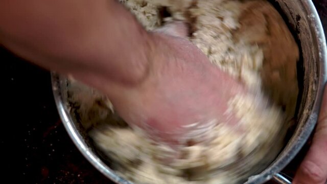 Italian Pizza Dough. chef mixes the ingredients for the dough with his hand DIY homemade dought concept.