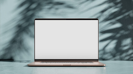 Laptop in gold color with blank screen on blue painted concrete background