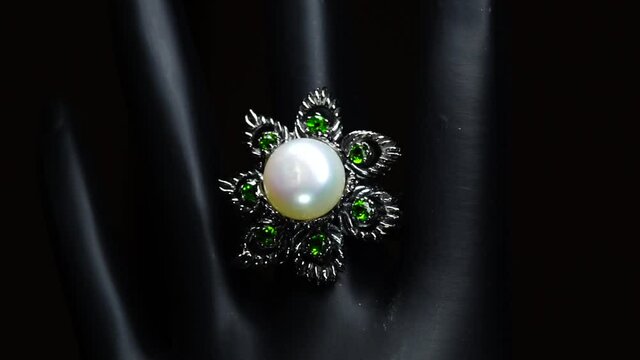 silver ring with natural gemstones on the black hand