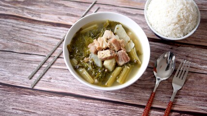 Chinese vegetables stew, mixture of white radish, Cantonese vegetable, pork belly and a bowl of rice on white background,  traditional Chinese food