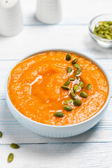 Creamy roasted pumpkin  soup  in a bowl. Space for text.