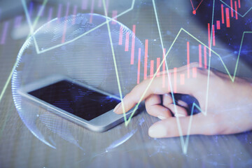 Double exposure of forex chart sketch hologram and woman holding and using a mobile device. Financial market concept.