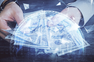 Multi exposure of financial theme drawing hologram and USA dollars bills and man hands. Business concept.