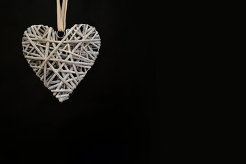 Valentine's Day background. heart made of wood on a black background. Valentine's Day concept. Flat view, top view, copy space