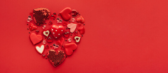 Festive composition with assorted hearts in shape of heart on red background. Top view, copy space. Valentine's day concept.