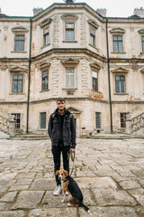 Fototapeta na wymiar man with an Estonian hound dog in the old castle
