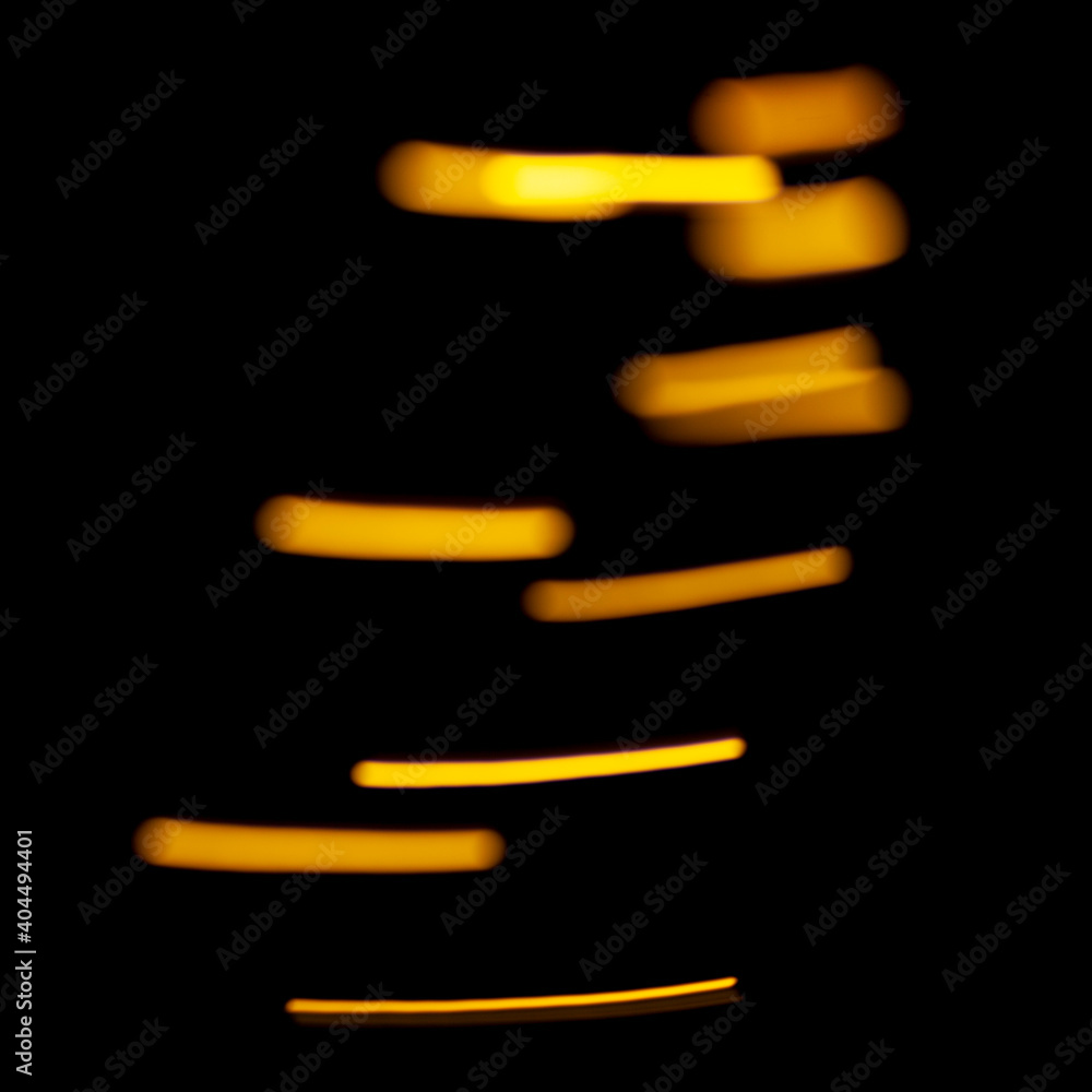 Poster bright yellow lights and sparks in defocus. bokeh effect on black background for overlay.