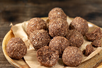 Chocolate coconuts. Chocolate balls with coconut. Chocolate candies or cookies with coconut, cinnamon and powdered sugar