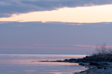 Fototapeta premium December sunrise with a beach and sea bay in the background