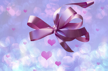 Valentine's Day. Beautiful background with beautiful pink ribbon with pink hearts and bokeh