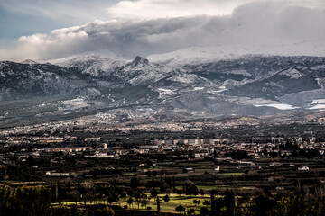 landscape with snowy mountains and Granada city line