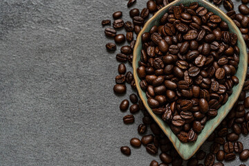 coffee beans in a cup on grey textured background-top view,copy space