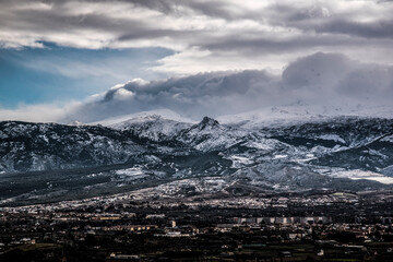 landscape with snowy mountains and Granada city line