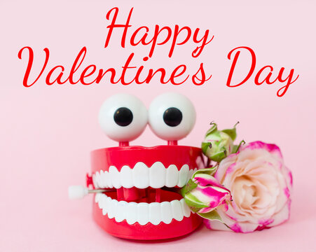 plastic toy teeth with eyes with a rose, creative minimal concept of happy valentine's day
