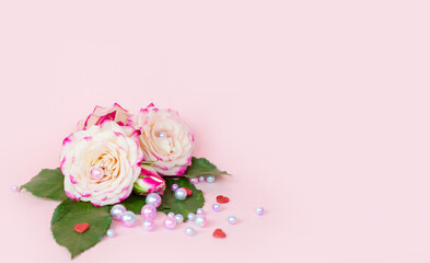 delicate bouquet of bushy peony roses with bright ribbons, pearls, feathers on a pink background, the concept of congratulations on Valentine's day