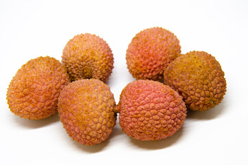 A close up view of a pile of lychees, a tropical fruit from Asia.
