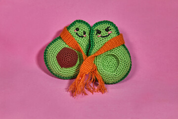 Cute crochet avocado toy, on pink background
Handmade knitted toy. 