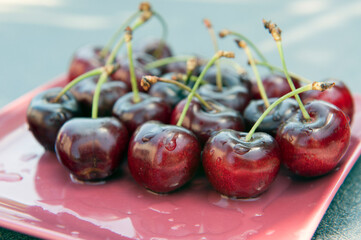 Close up of plate full with freshly picked and washed cherries