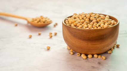 soybeans in wooden bowl with wooden spoon on the table.