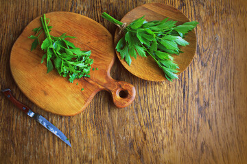 Lovage herb on cutting board. Woden background