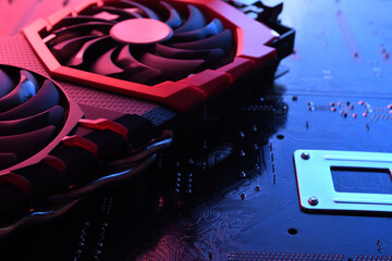 Computer game graphics card, videocard with two coolers on circuit board ,motherboard background. Close-up. With red-blue lighting