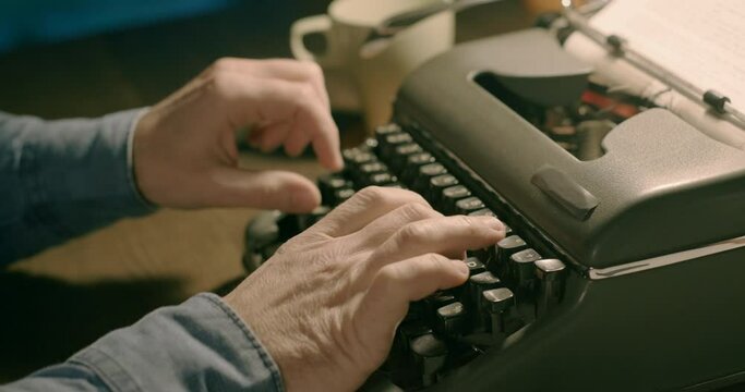 Businessman typing on a vintage typewriter
