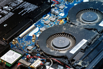 Dusty fan inside the laptop during servicing. Selective focus. close up, macro.