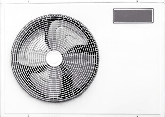 White air conditioner condenser unit outside the building.