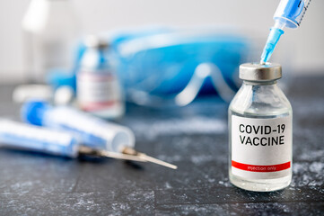 A single bottle vial of Covid-19 vaccine. Medical concept vaccination hypodermic injection...