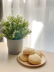 Baked english scone serve for coffee break on wooden dish.