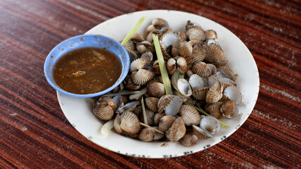 Fresh boiled mussels in a plate cooked by malaysian street hawker. Asian Food