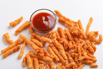 Delicious Homemade kurkure snack with tomato ketchup on white background