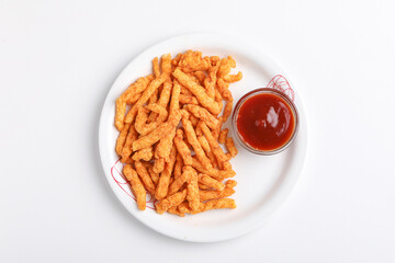 Delicious Homemade kurkure snack with tomato ketchup on white background