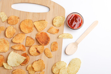 Potato chips with tomato ketchup isolated on white background