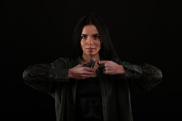 beautiful young brunette woman with a knife on a black background