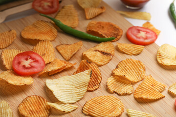 Potato chips with tomato ketchup isolated on white background