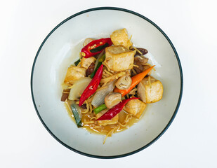 Thai stir fried ginger with tofu, mushrooms and red and orange chillis on a white background (Famous Thai food)