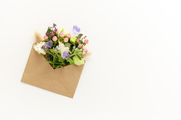 Composition with craft envelope and delicate flowers