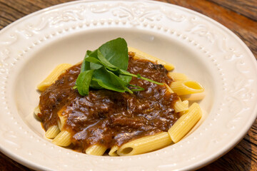 Penne pasta with oxtail ragout sauce.