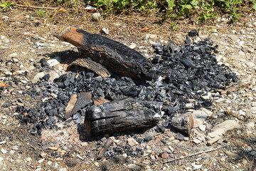 Embers of an extinct fire on a sea pebble beach