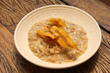 Pork risotto with fried banana-da-terra fruit chips.