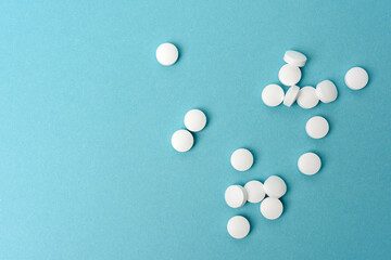 White round pill for healthcare. Medical treatment, bue background