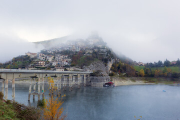 A foggy day at Lake Turano. The colors of autumn in Castel di Tora in Rieti