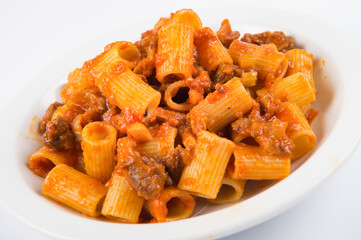 pasta con coda alla vaccinara is a typical dish from the area of Rome and the Lazio region prepared with cooked beef tail, isolated on white background