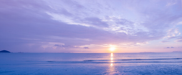 Fototapeta na wymiar Beautiful panoramic tropical purple blue sea sunset and yellow clouds background