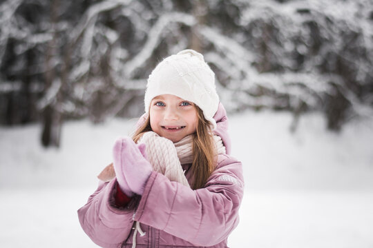 Beautiful little girl five years old portrait in a snowy city park