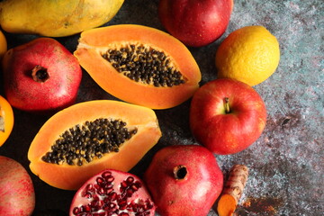 red pomegranates, papaya seeds, fruit full of juice, vitamins, orange papaya, colorful fruit, apple, fresh turmeric cut in half