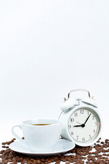 Morning cup of coffee and alarm clock.White background.

