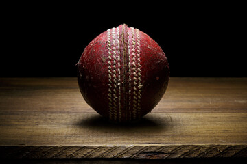 Leather Cricket ball close-up on a wooden surface fine art with copy space - 404532650